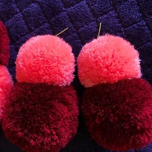 Two pairs custom made pom pom earrings.